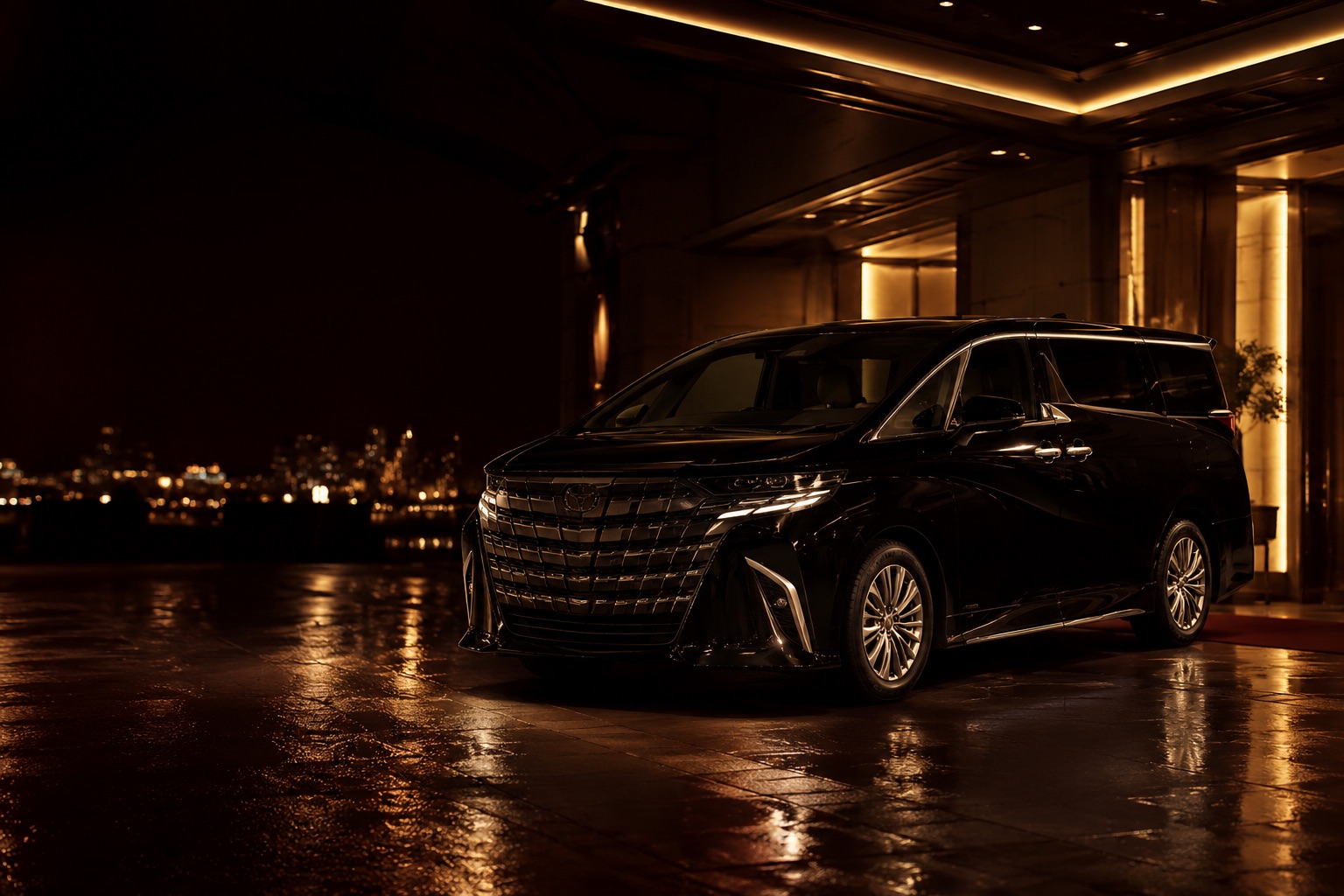 Black Toyota Alphard at night outside a warmly lit entrance, city lights beyond