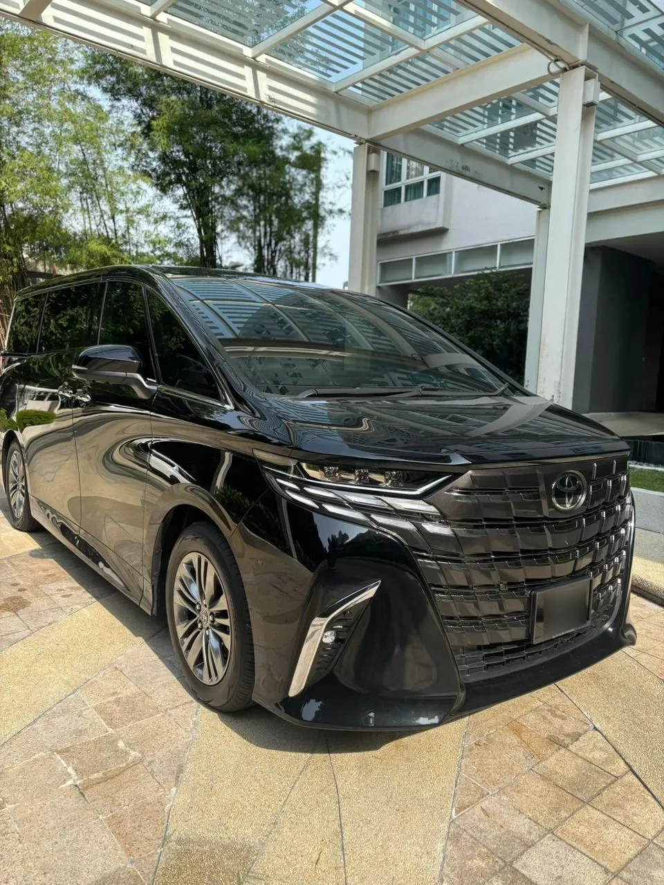 Toyota Alphard AGH40 front grille under a hotel canopy