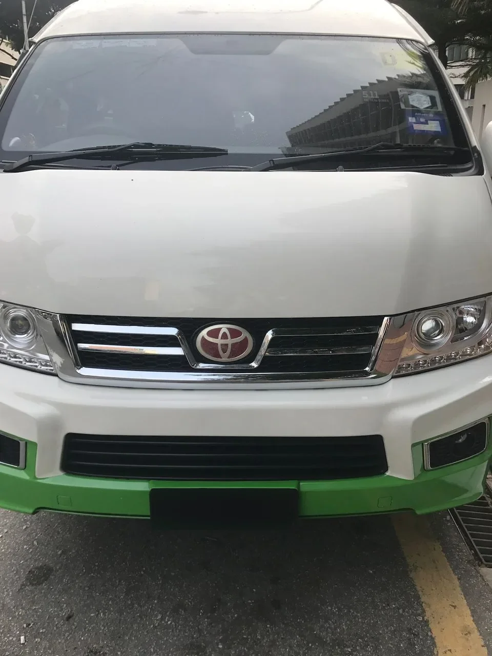White 14-seater van, front view